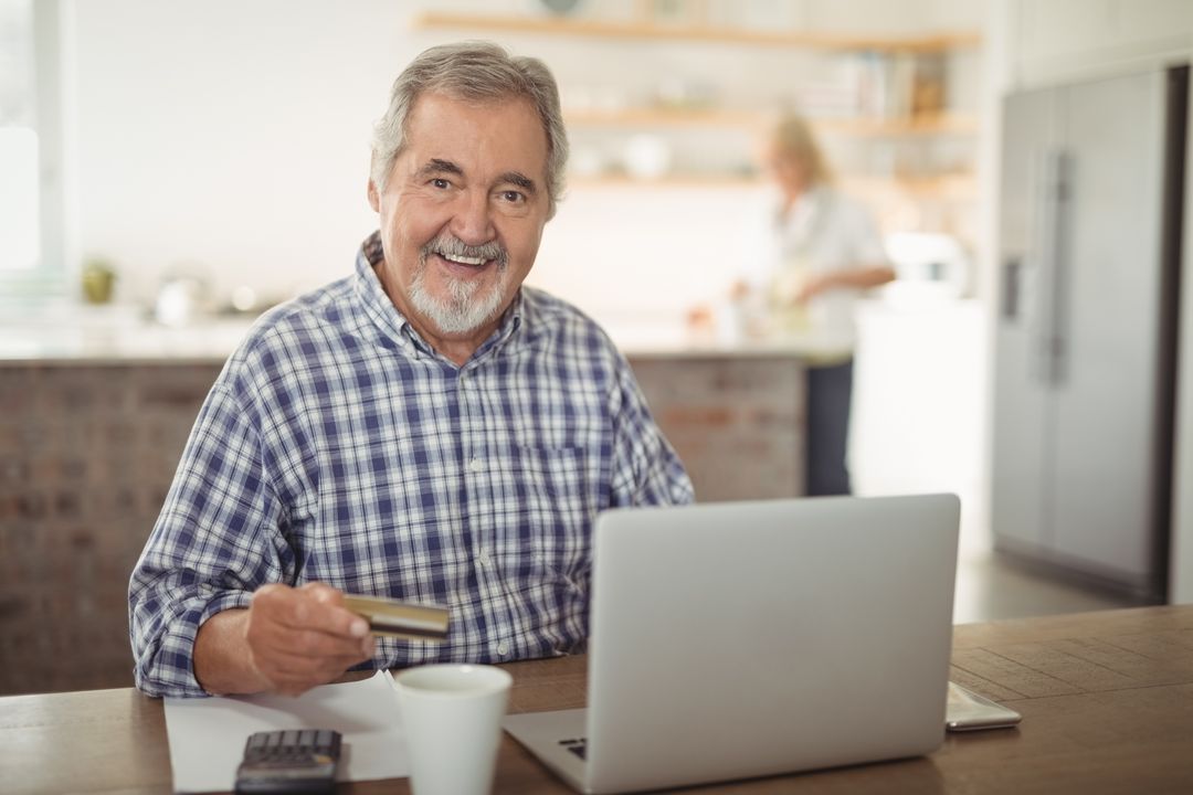 Image of an Elderly Man Being on his Laptop and Smiling into the Camera