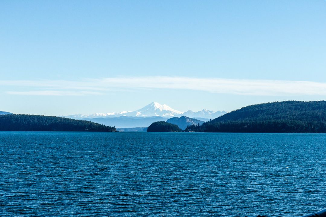 a lake with a mountain in the background - Free Images, Stock Photos and Pictures on Pikwizard.com