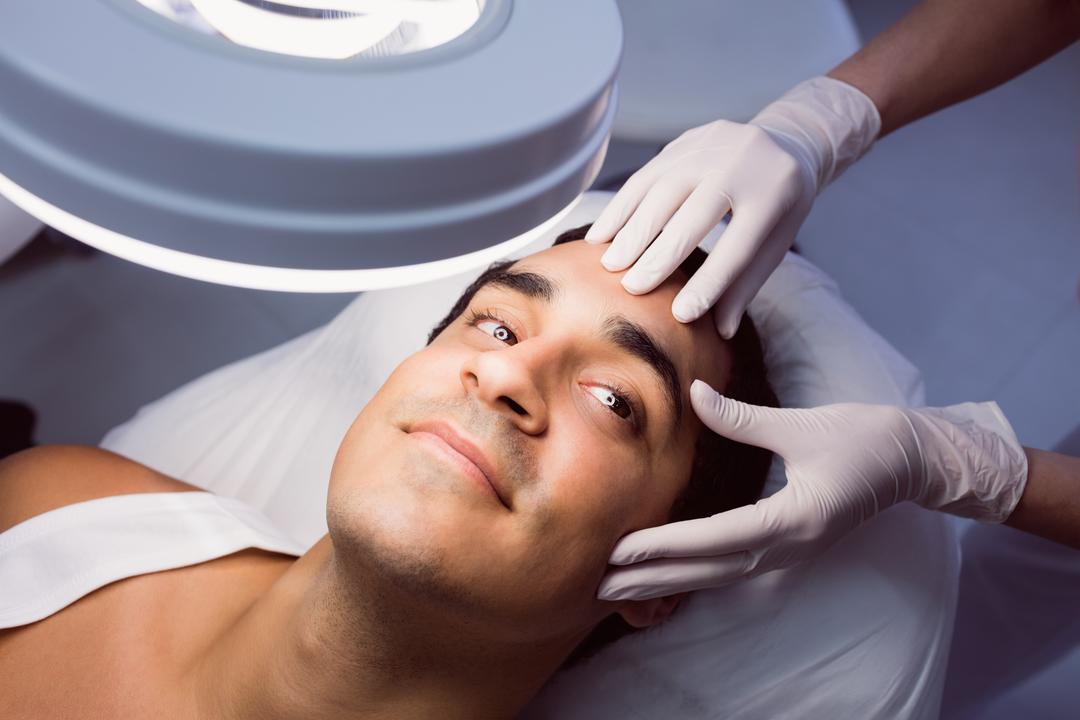 Doctor examining mans face for cosmetic treatment - Free Images, Stock Photos and Pictures on Pikwizard.com