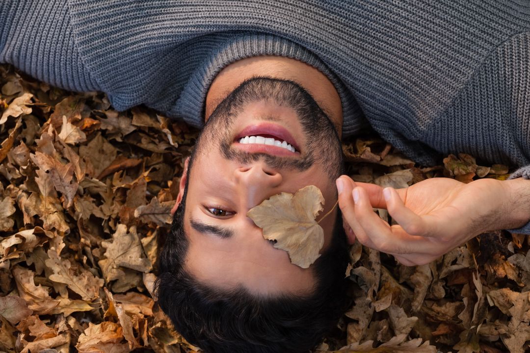 Overhead of man lying on autumn leaves - Free Images, Stock Photos and Pictures on Pikwizard.com
