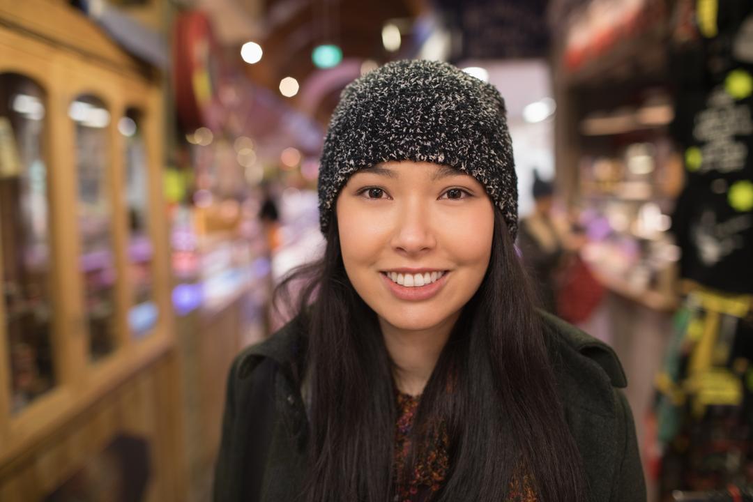 Image of a woman smiling at the camera in a supermarket - Find eye-catching images using PikWizard - Image