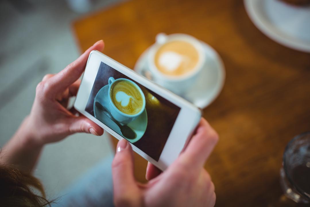 Image of a Person Who is Taking a Picture of Her Coffee with her Smartphone