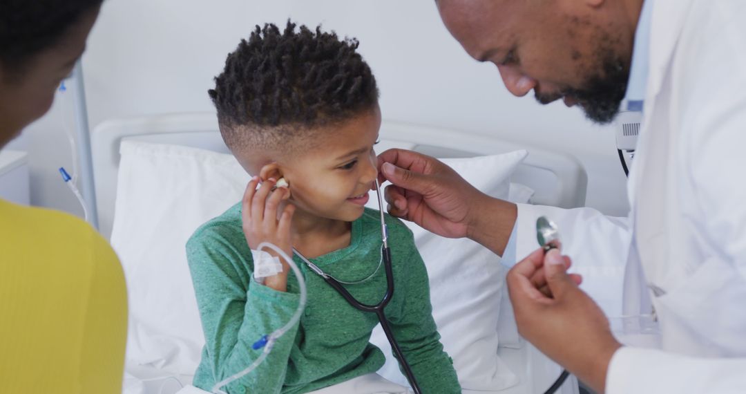 African american male doctor examining child patient, using stethoscope at  hospital from Pikwizard