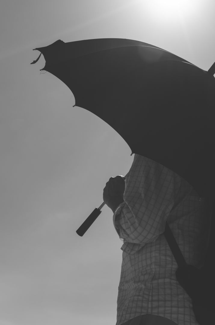 a person holding an umbrella from Pikwizard