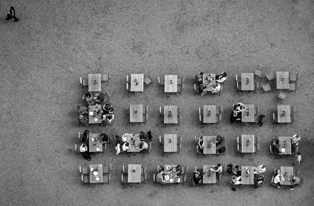 Black and white aerial shot of picnic benches