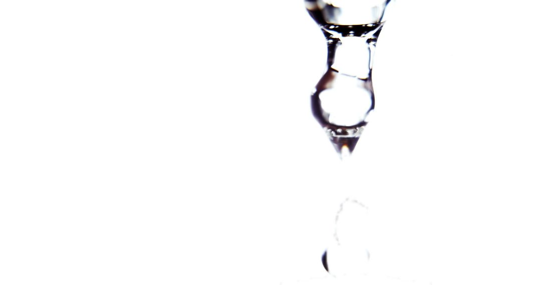 Drop of water falling down on white background from Pikwizard