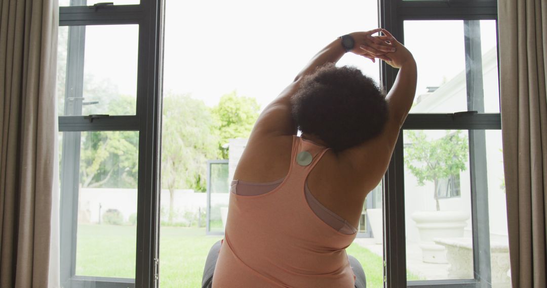 Image of back of plus size african american woman practicing yoga at home - Free Images, Stock Photos and Pictures on Pikwizard.com