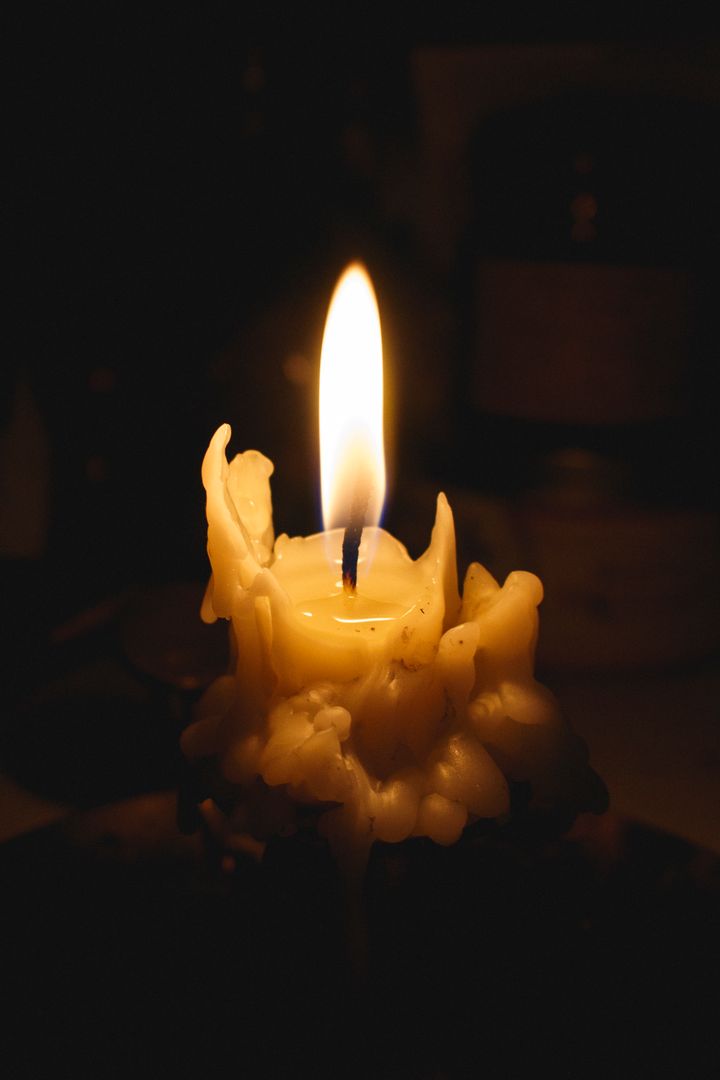 a candle lit in the dark - Free Images, Stock Photos and Pictures on Pikwizard.com
