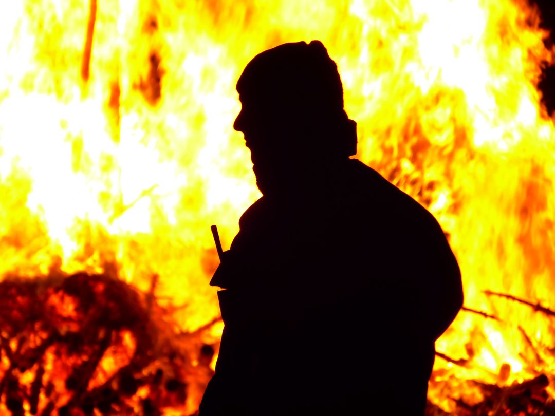 a man standing in front of a fire - Free Images, Stock Photos and Pictures on Pikwizard.com