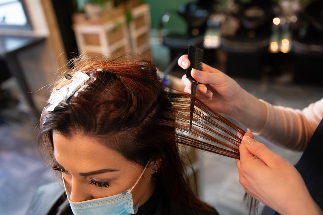 Premium Photo  Hairdresser is dying female hair, making hair