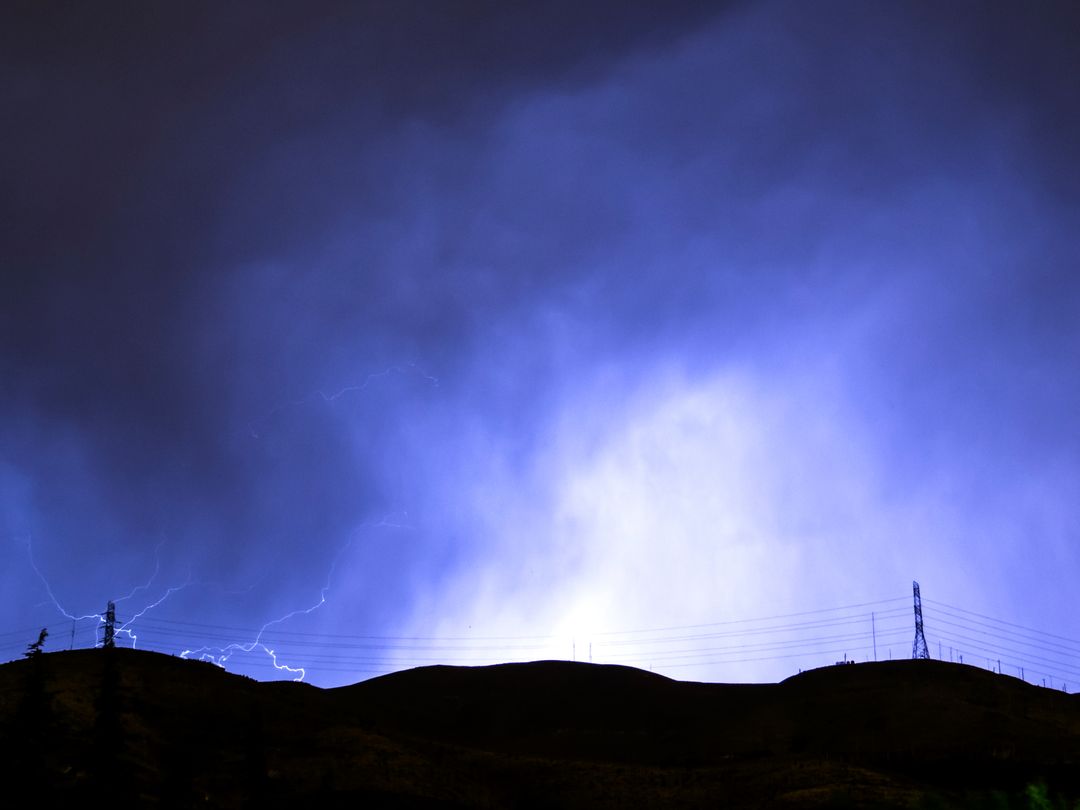 lightning striking over a hill - Free Images, Stock Photos and Pictures on Pikwizard.com