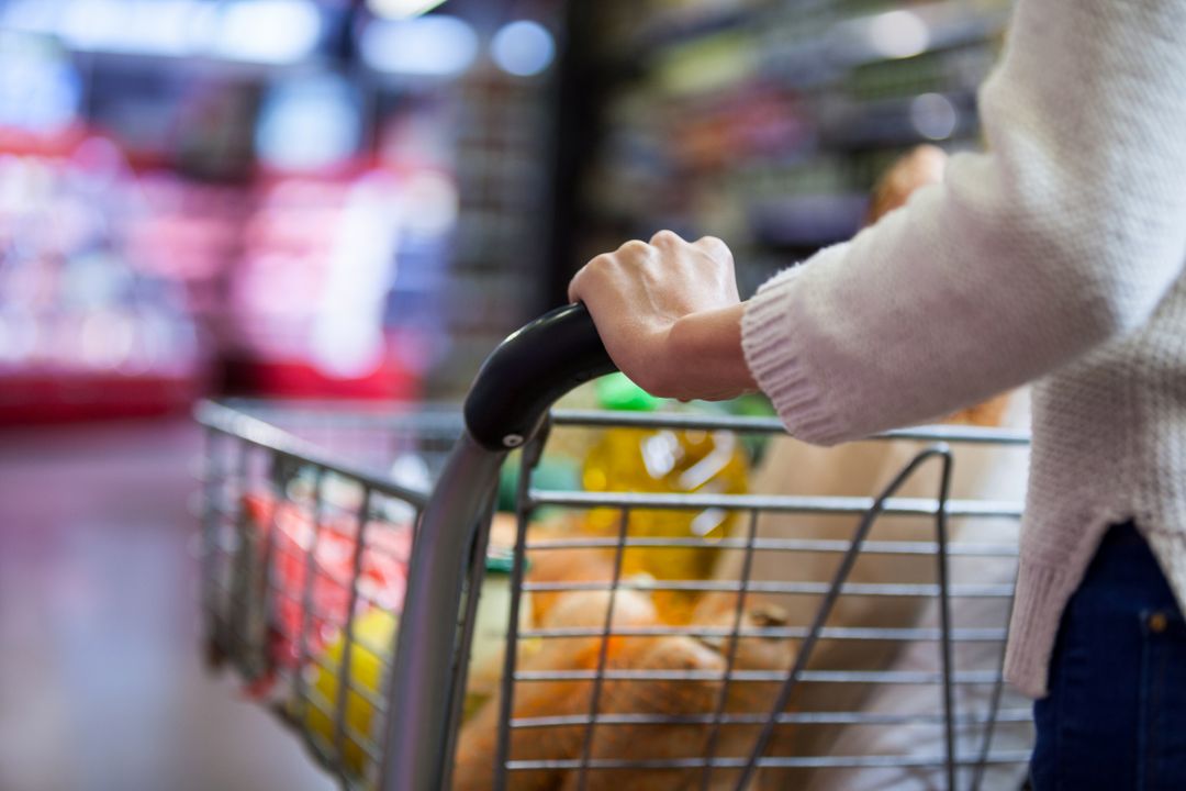 Woman pushing a shopping cart full of groceries