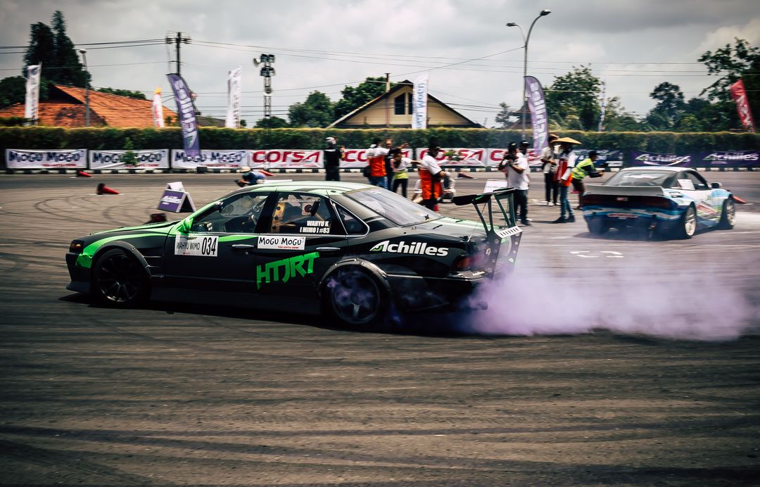 Car drifting, Blurred of image diffusion race drift car with lots of smoke  from burning tires on speed track Stock Photo