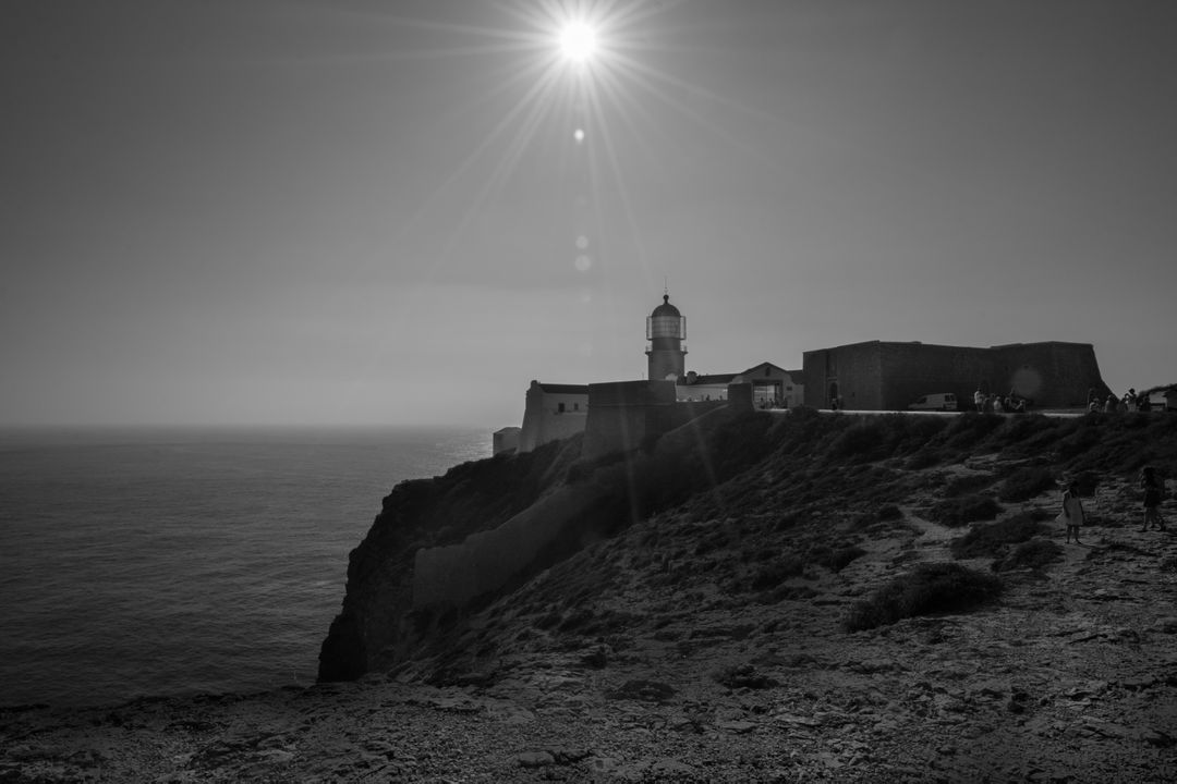 a lighthouse on a cliff overlooking the ocean - Free Images, Stock Photos and Pictures on Pikwizard.com
