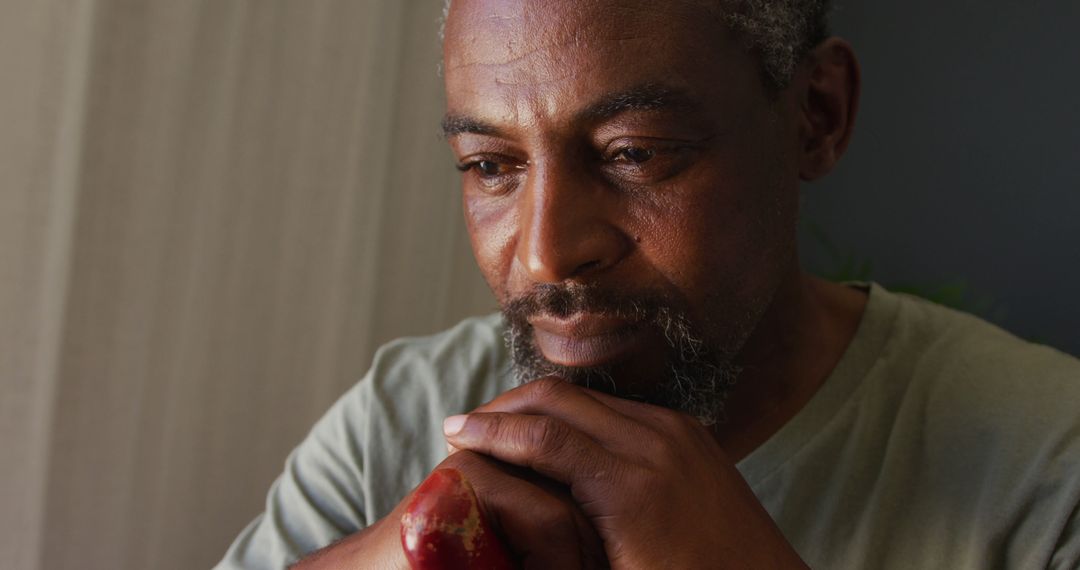 Close up of african american man holding a walking stick at home - Free Images, Stock Photos and Pictures on Pikwizard.com