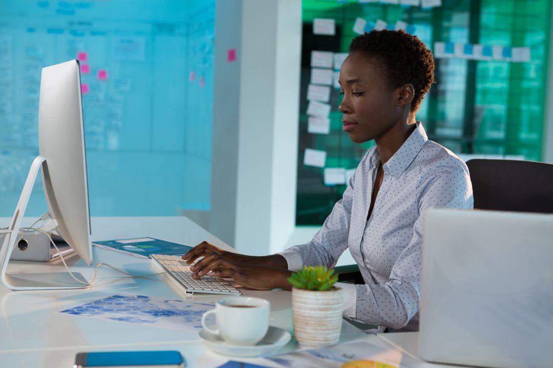 Female blogger typing on her desktop in an office space - Simple but powerful tactics for crafting compelling ad copies that drive sales - Image