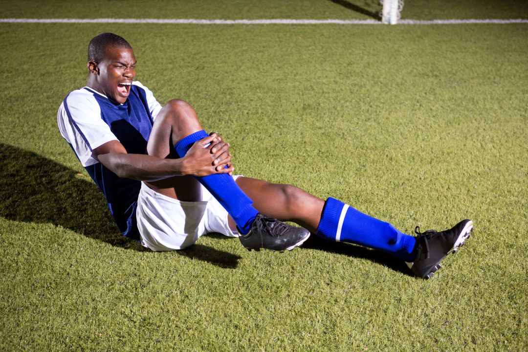 Young male soccer player shouting in agony with knee pain - Free Images, Stock Photos and Pictures on Pikwizard.com