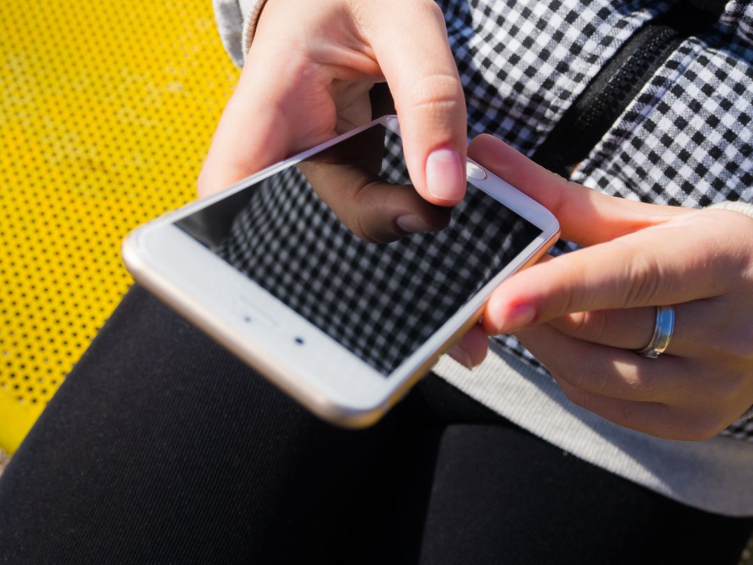 Overhead image of a person marketing on their phone - Expert online marketing tips to improve your digital strategy and make more money - Image