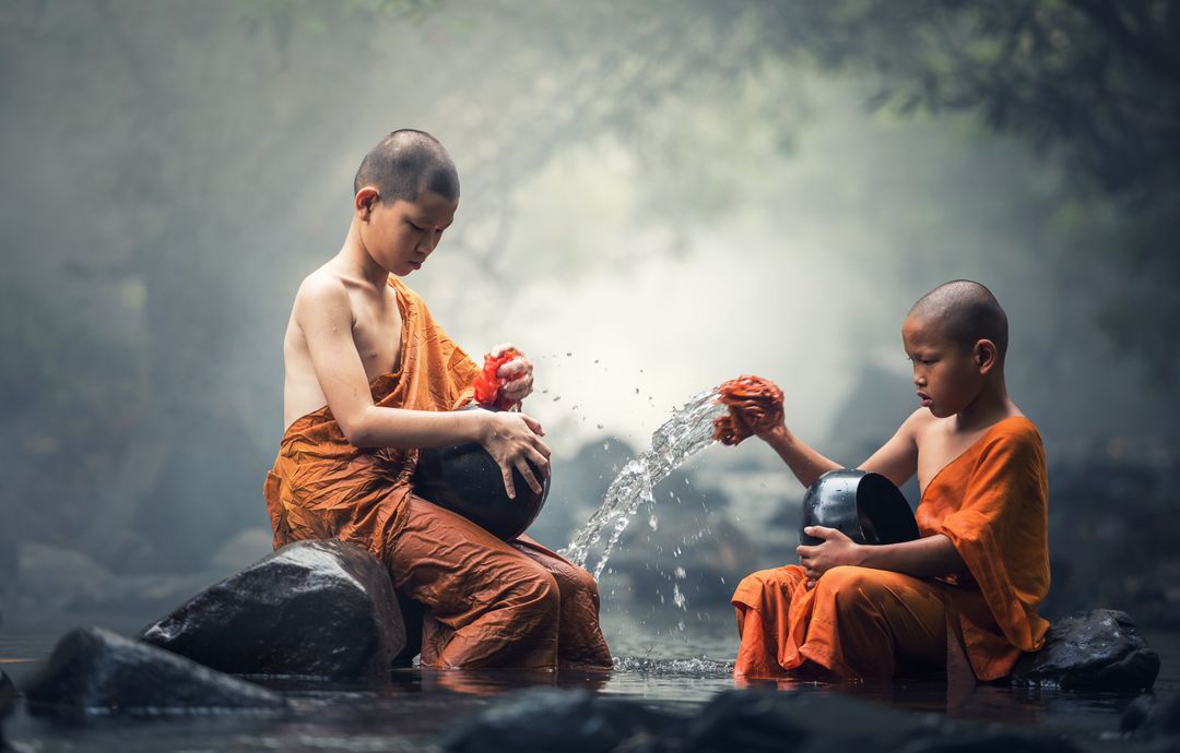 two young monks playing in the water - Free Images, Stock Photos and Pictures on Pikwizard.com