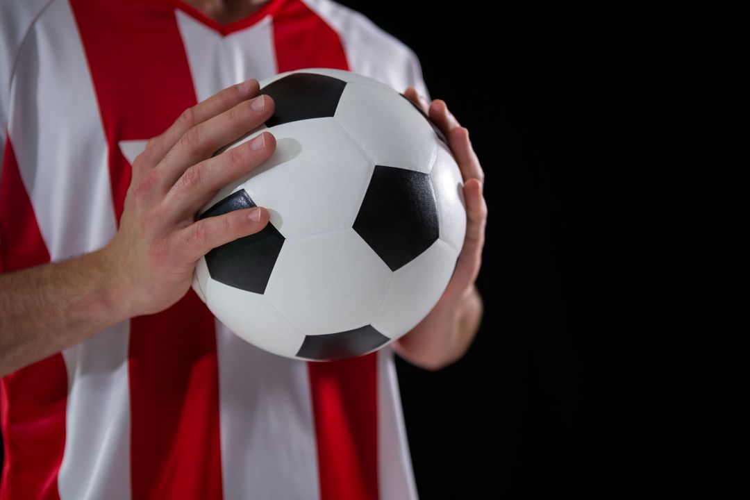 Football Player Holding Football With Both Hands Stock Photo