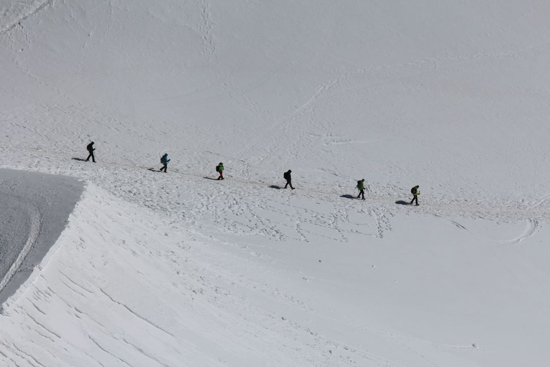 a group of people skiing down a mountain - Free Images, Stock Photos and Pictures on Pikwizard.com