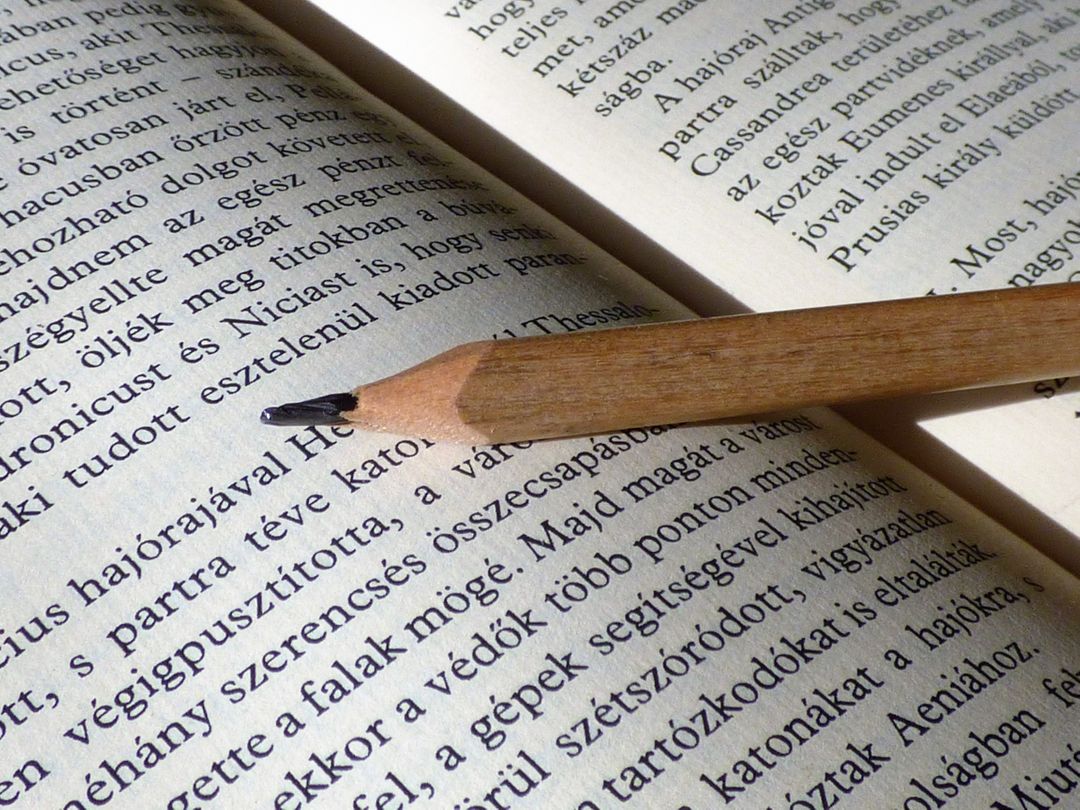 a pencil resting on an open book - Free Images, Stock Photos and Pictures on Pikwizard.com