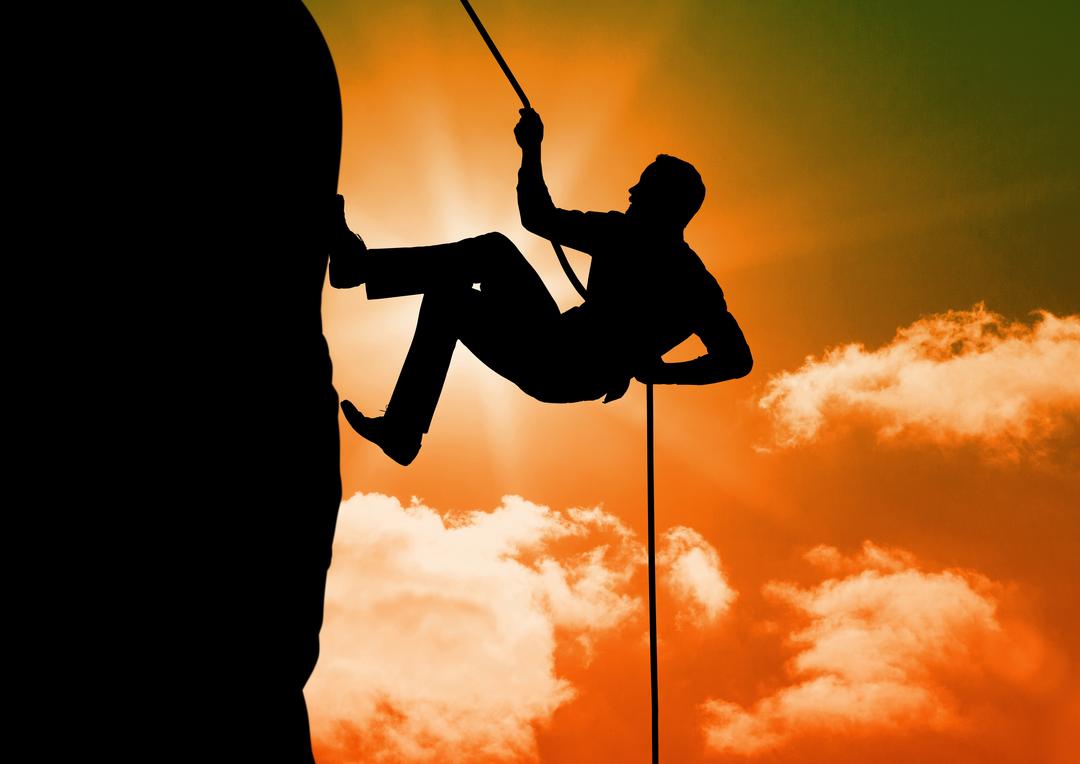 Silhouette of man climbing on mountain against sunny sky background from  Pikwizard