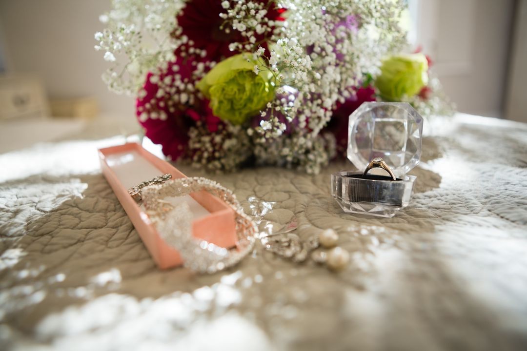 Image of wedding flowers with ring on lace tablecloth