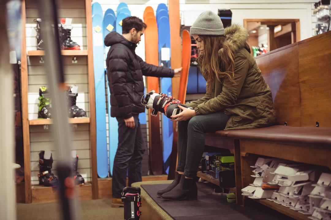 Image of a couple shopping for winter ski equipment