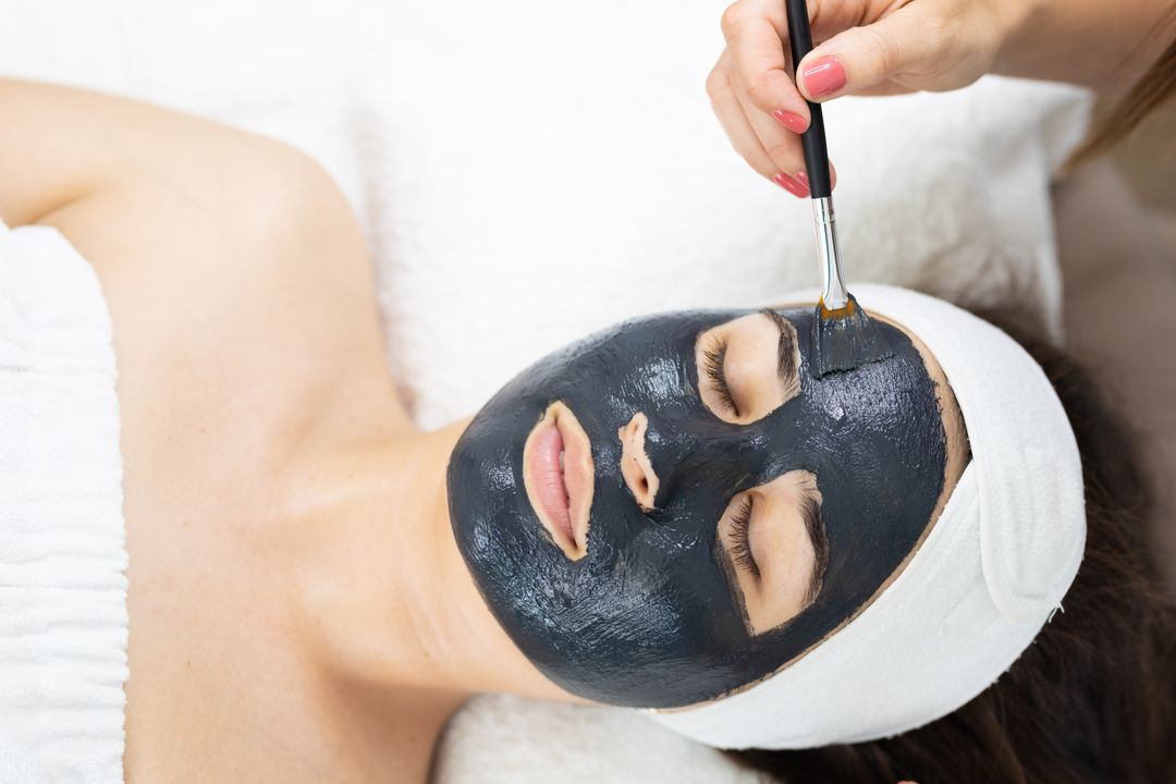 Image of a woman with a face mask applied by a beautician - Meaning and use of hero image in web design - Image