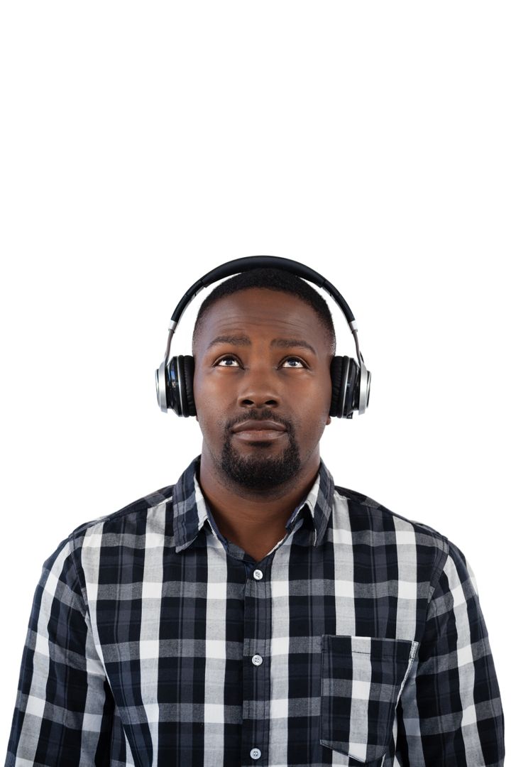 Man listening to music on headphones against white background - Free Images, Stock Photos and Pictures on Pikwizard.com