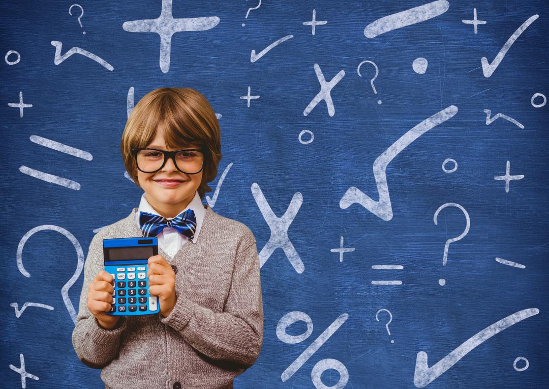 Schoolboy holding calculator in front of a chalkboard - Free Images, Stock Photos and Pictures on Pikwizard.com