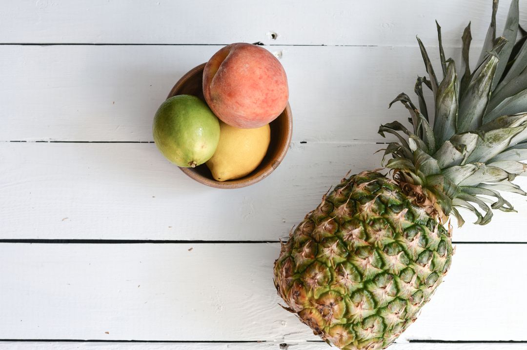 Image of a Pineapple and Other Fruits on a Wooden Table