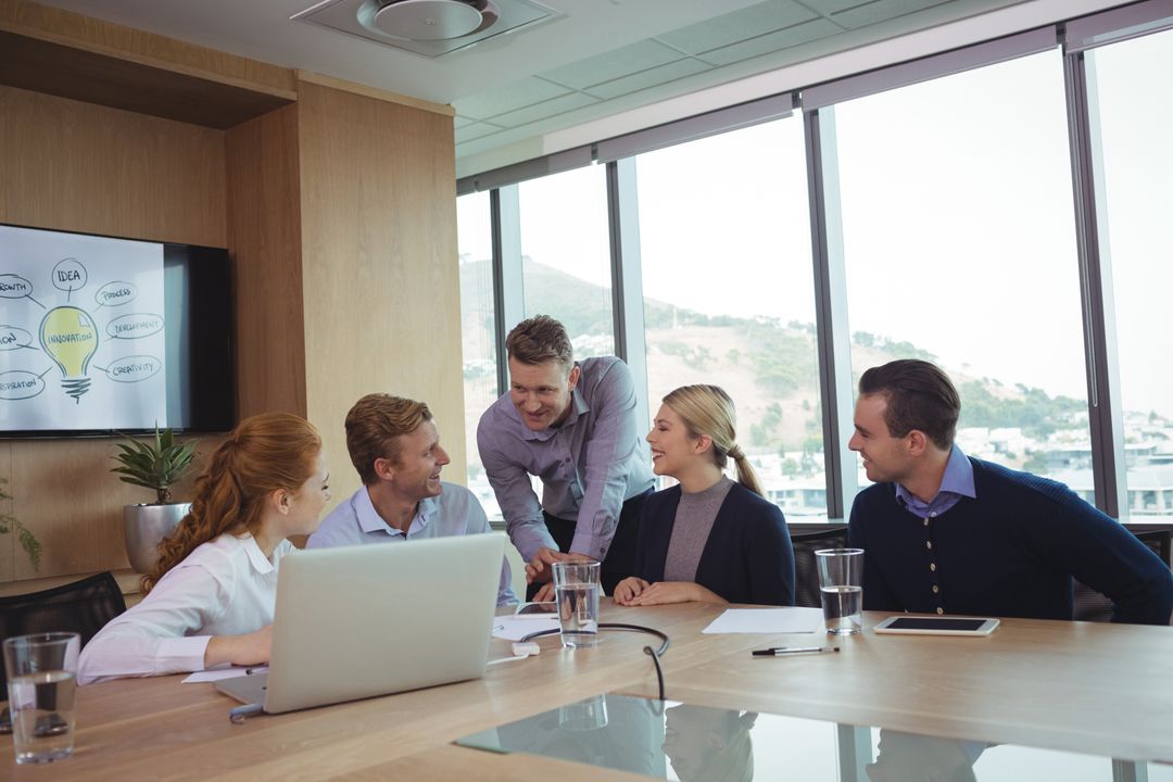 Image of a Group of Five People Discussing Something in a Meeting