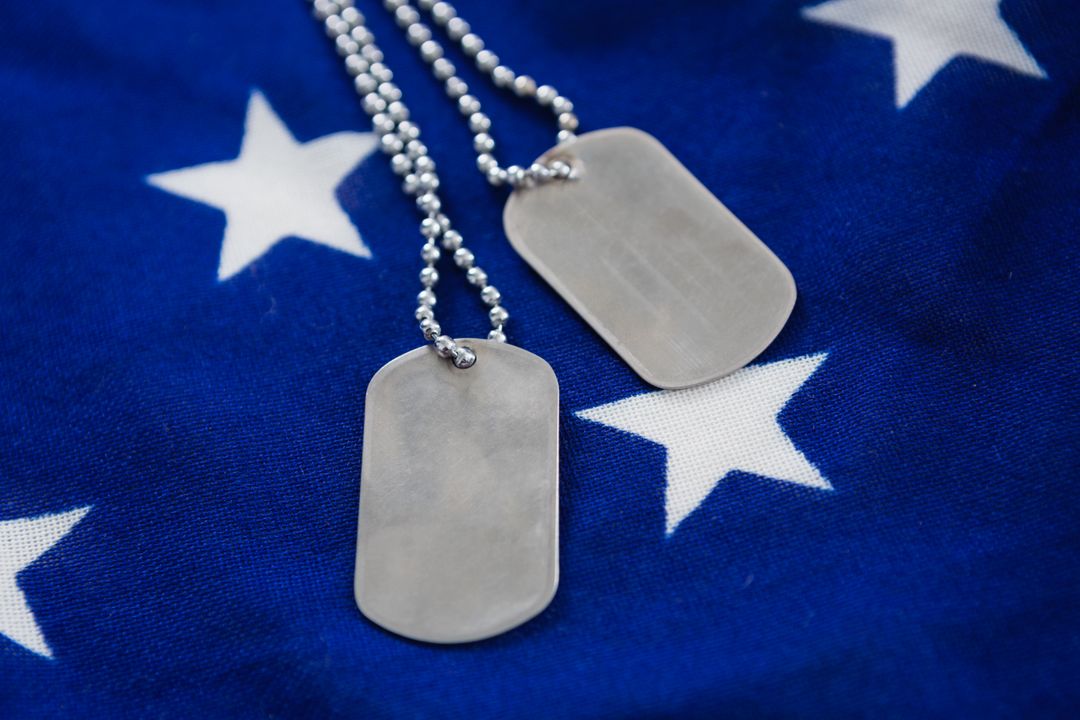 Dog tag chain on an American flag - Free Images, Stock Photos and Pictures on Pikwizard.com