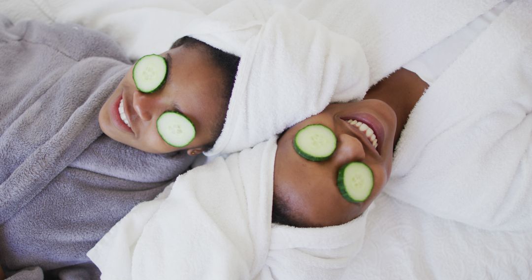 Two Women Relaxing with Cucumber Slices during Spa Treatment from Pikwizard