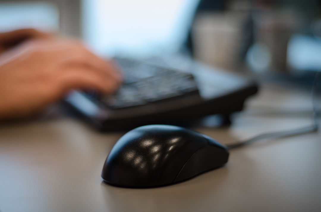 Blurry Image of a Person Typing on the Keyboard