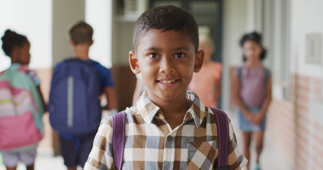 Image of happy biracial boy standing at school corridor - Free Images, Stock Photos and Pictures on Pikwizard.com