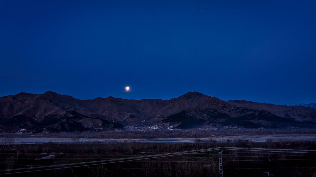 a moon rising over mountains - Free Images, Stock Photos and Pictures on Pikwizard.com