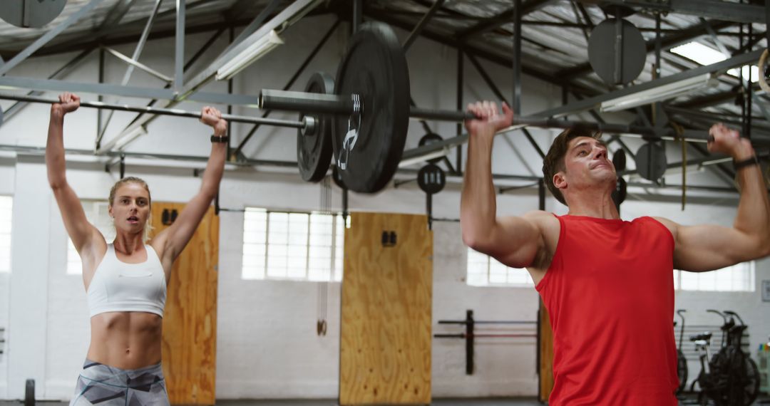 Fit People Working Out In Weights Room At The Gym Stock Photo