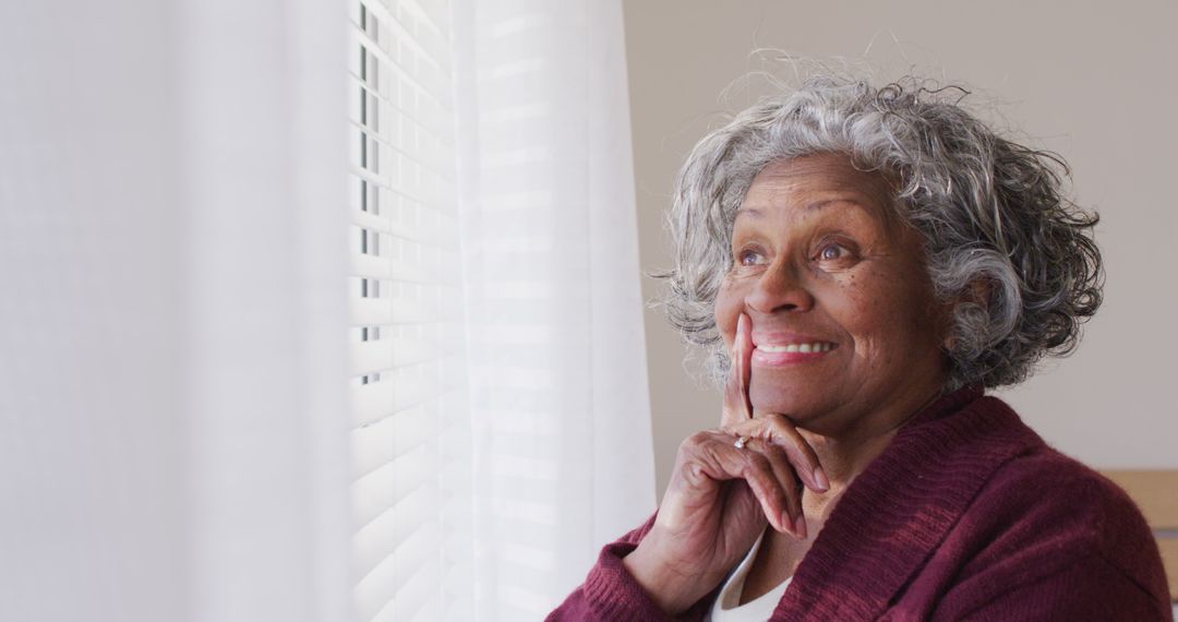 Portrait Of Smiling African American Senior Woman Looking Through