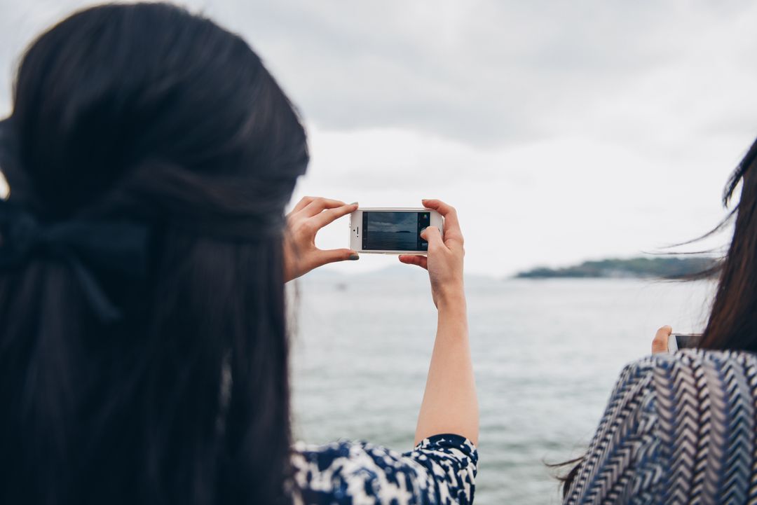 Image of two woman taking a picture with a smartphone