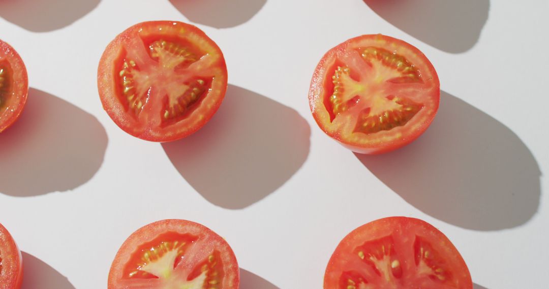 Image of fresh halved red tomatoes on white background - Free Images, Stock Photos and Pictures on Pikwizard.com