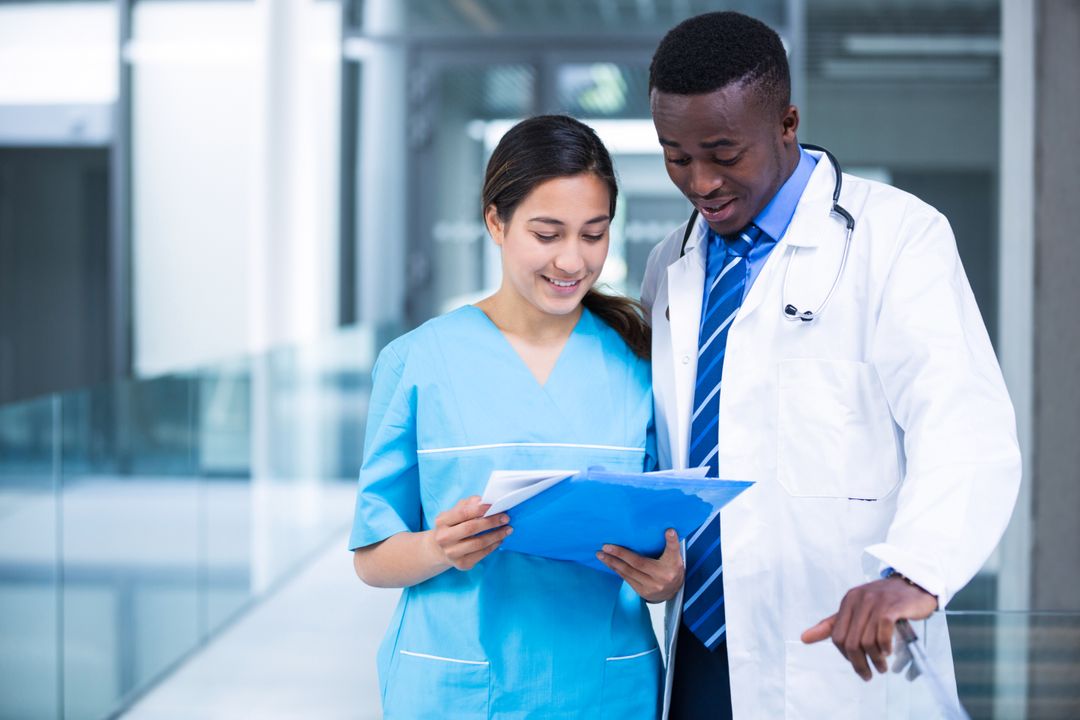 Doctor and Nurse Discussing Medical Report in Hospital - Download Free  Image from Pikwizard