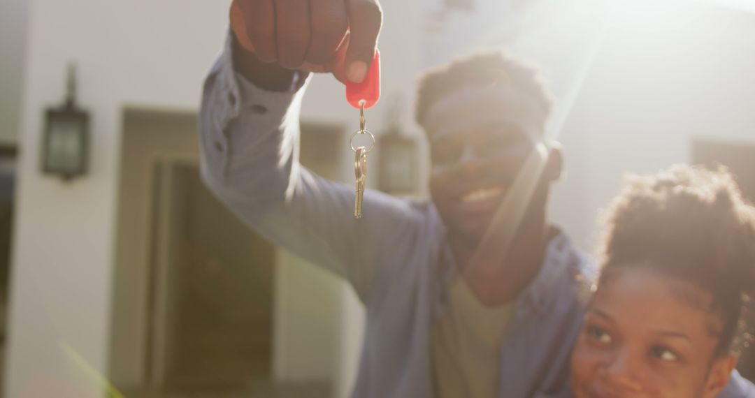 Image of happy african american couple embracing and showing keys to new house - Free Images, Stock Photos and Pictures on Pikwizard.com