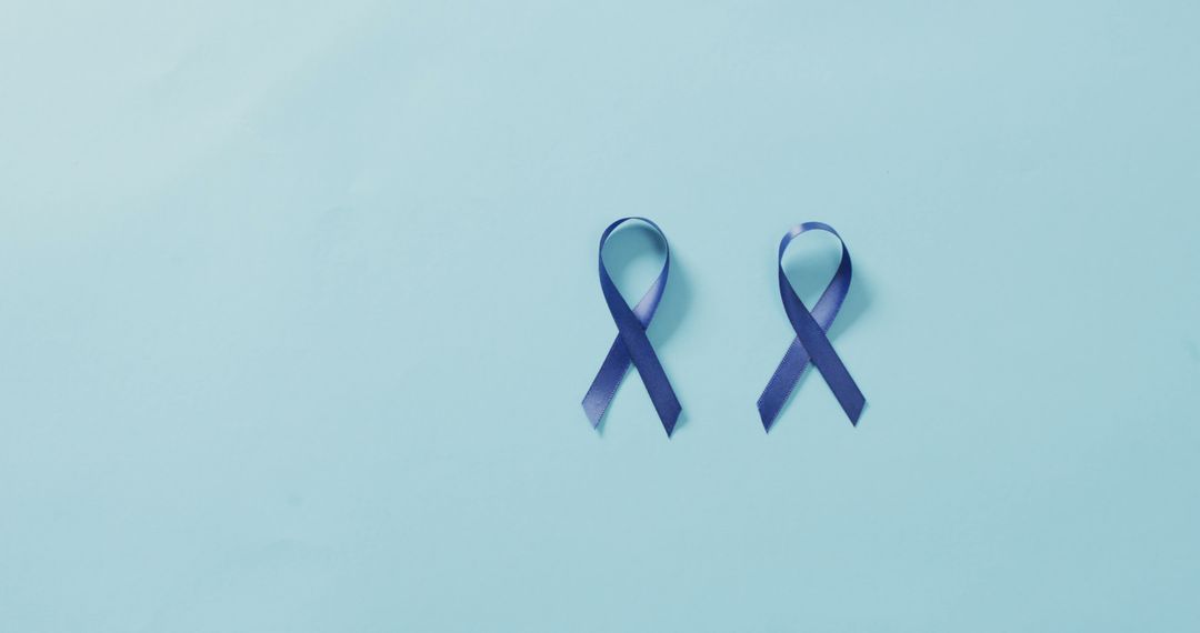 Image of dark blue colon cancer ribbon on white background from Pikwizard