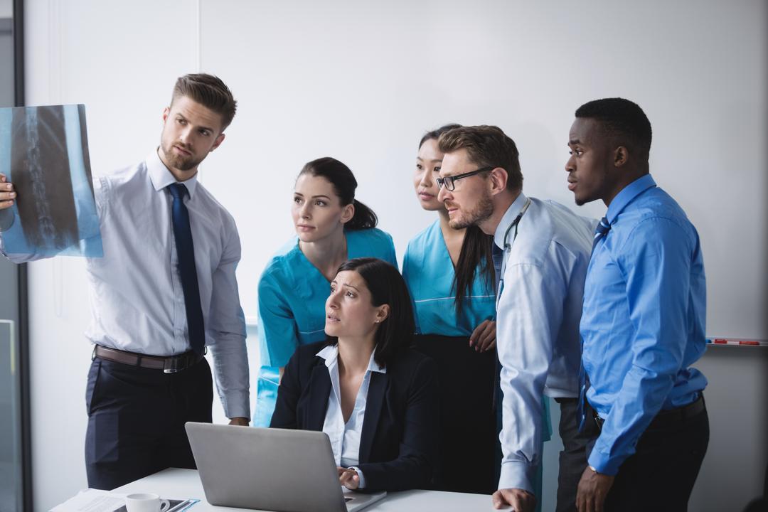 Medical team looking at report - Everything you need to know about stock photos - Image