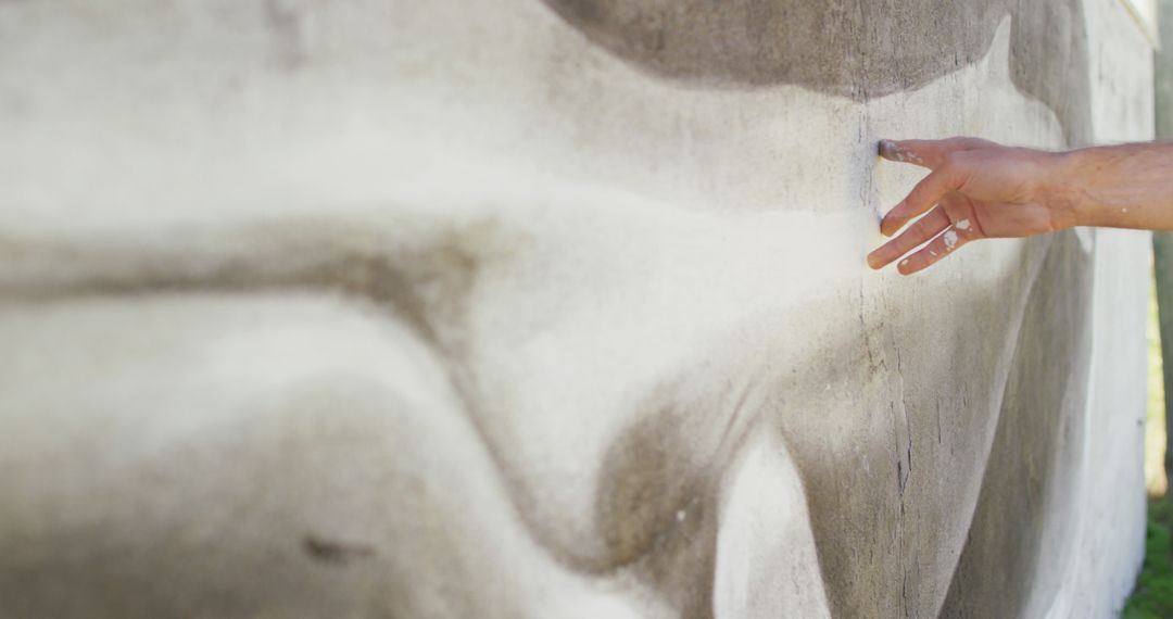 Image of hand of caucasian male artist touching mural on wall - Free Images, Stock Photos and Pictures on Pikwizard.com
