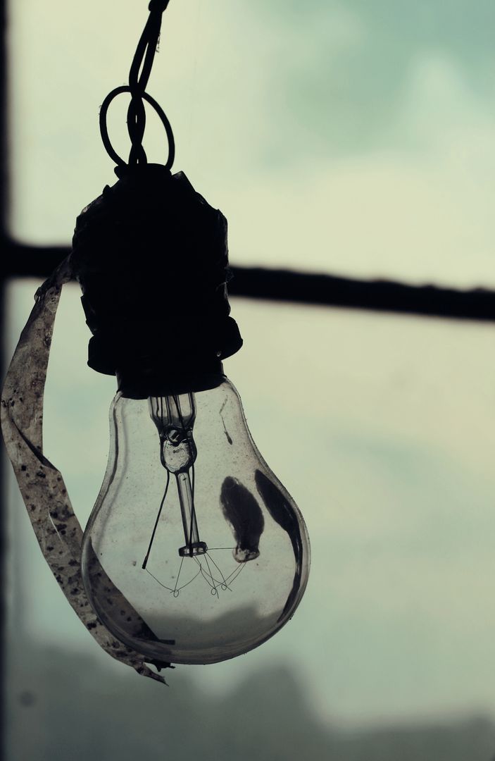 a light bulb hanging from a string - Free Images, Stock Photos and Pictures on Pikwizard.com