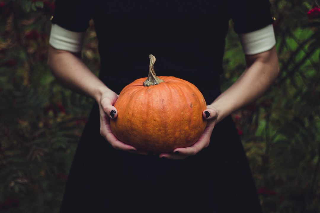 Image of a Woman Holding a Pumpkin